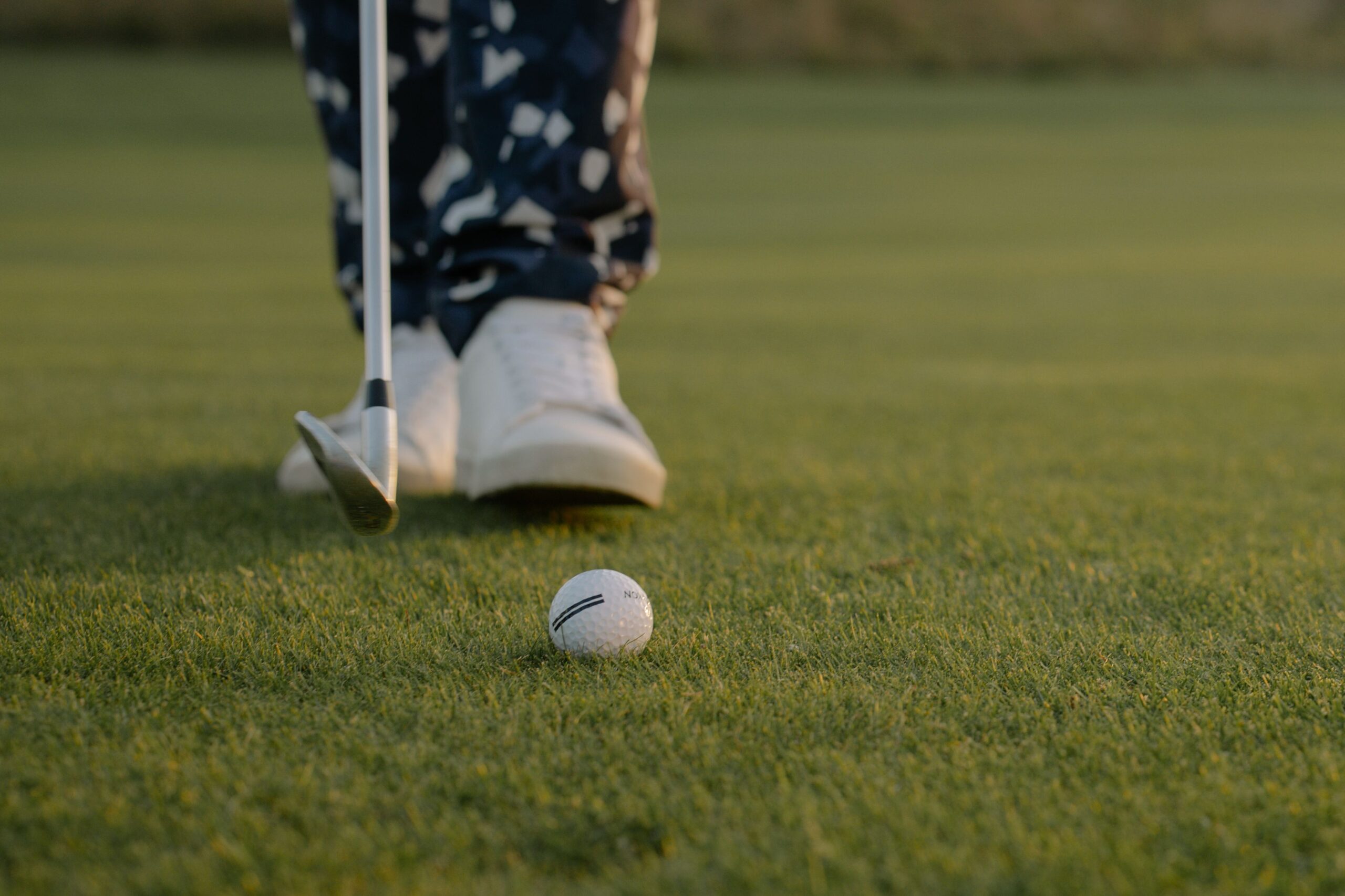 Golfer preparing to putt on green course